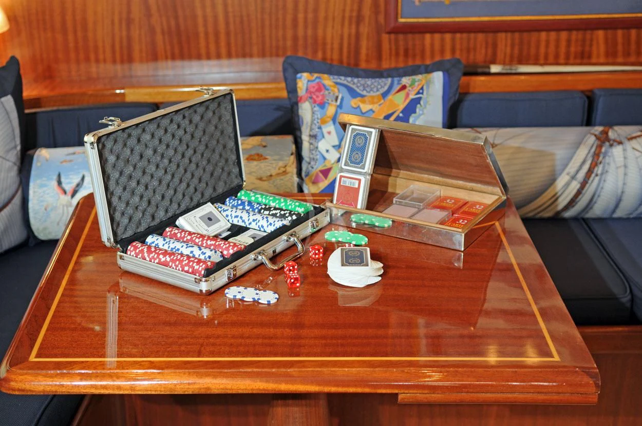 a table with a group of game controllers on it aboard OFELIA Yacht for Sale