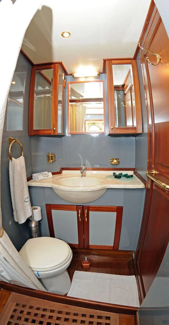 a bathroom with a toilet and a sink aboard OFELIA Yacht for Sale