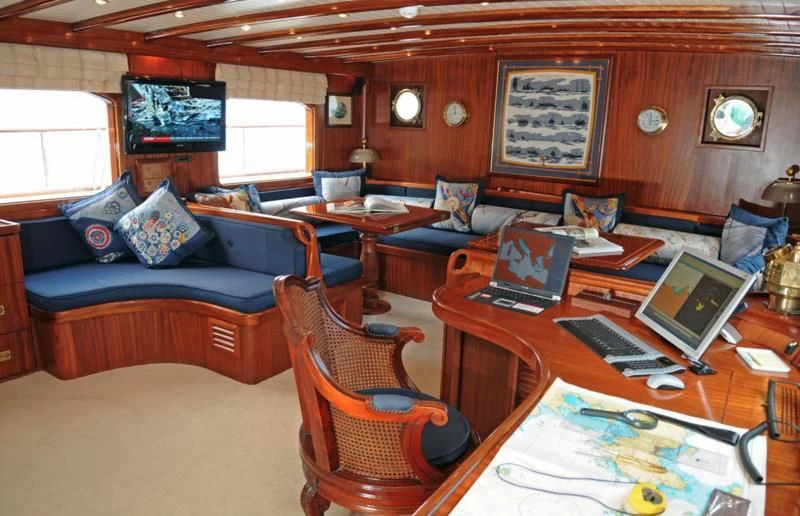 a living room with a couch and laptops aboard OFELIA Yacht for Sale