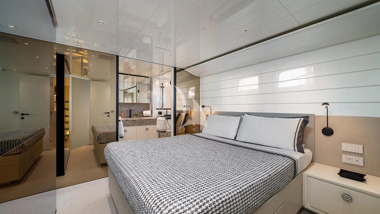 a bedroom with a bed and a mirror aboard ADIOS Yacht for Charter