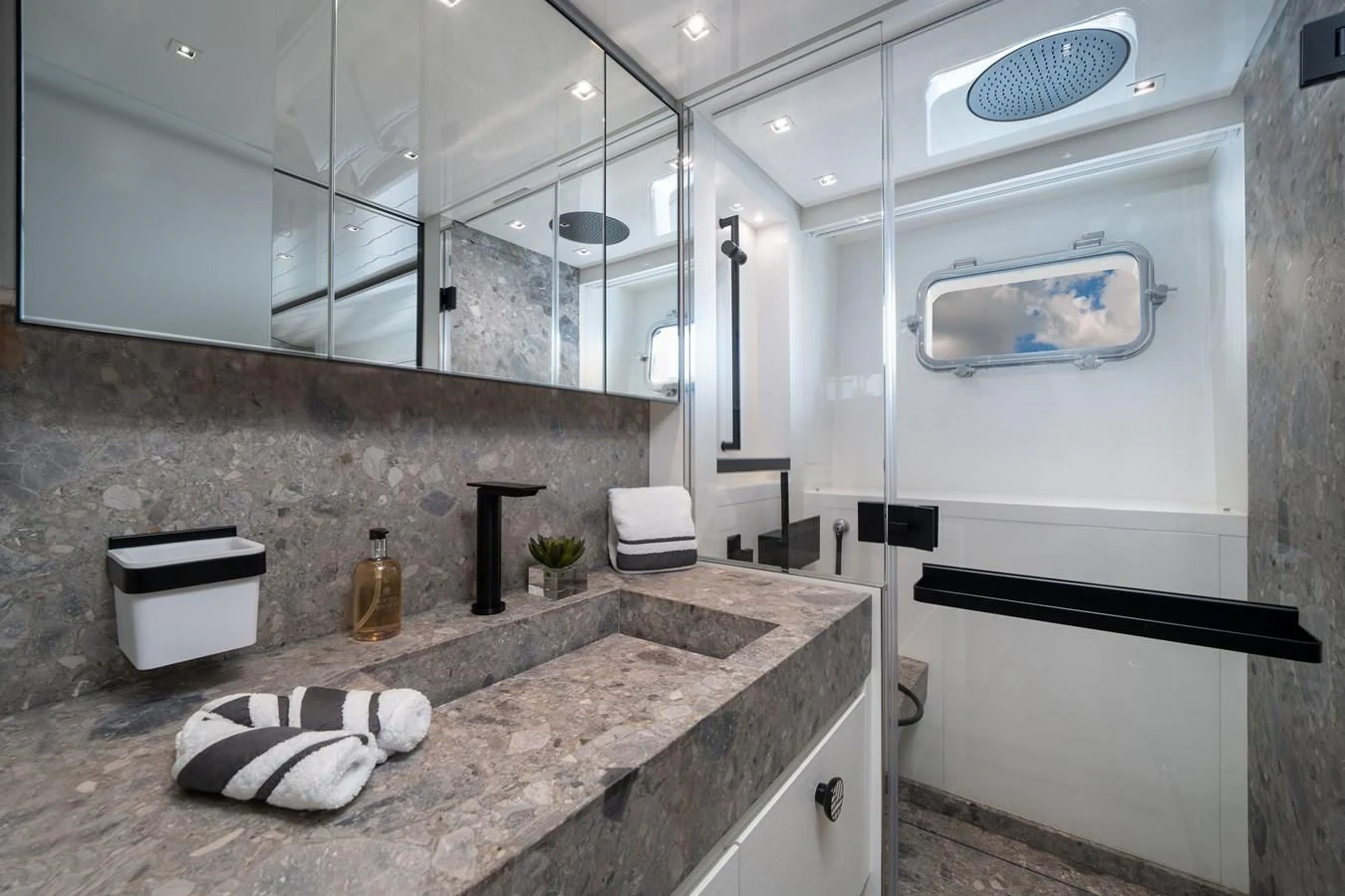 a bathroom with a sink and a mirror aboard ADIOS Yacht for Charter