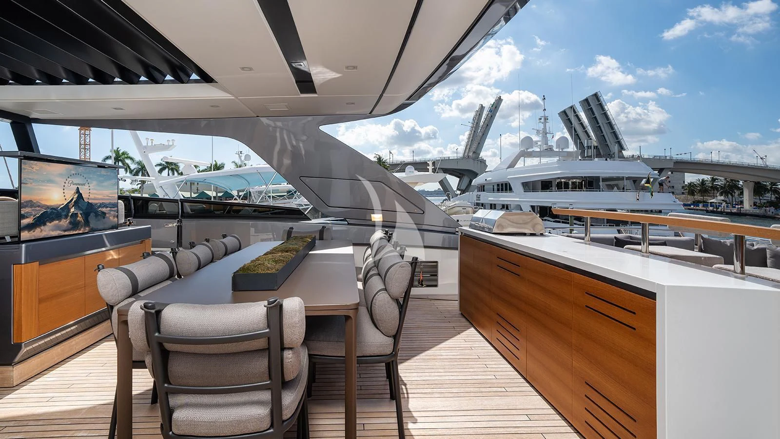 a deck with a table and chairs aboard ADIOS Yacht for Charter