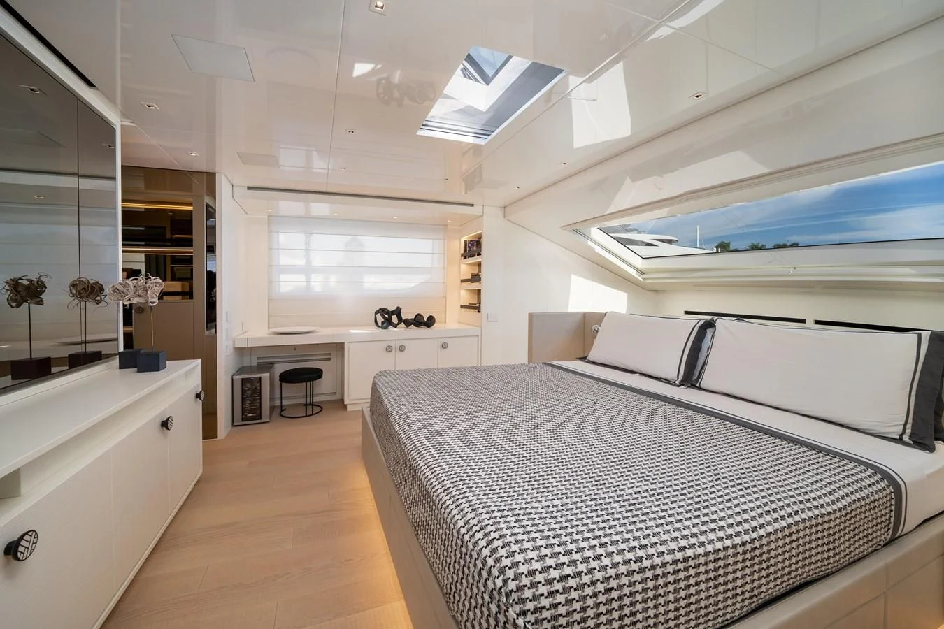 a room with a bed and a desk aboard ADIOS Yacht for Charter