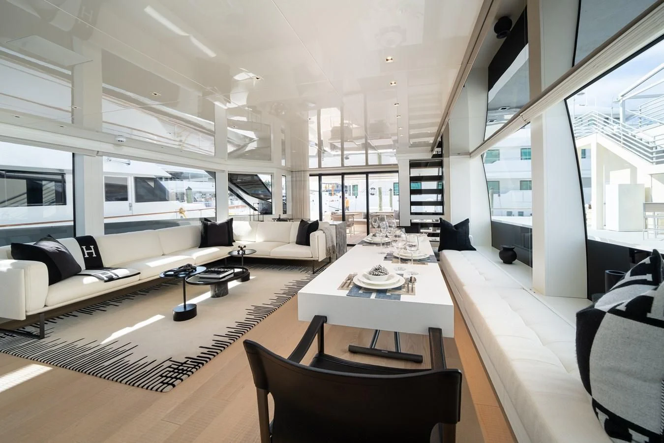 a room with a table chairs and a couch aboard ADIOS Yacht for Charter
