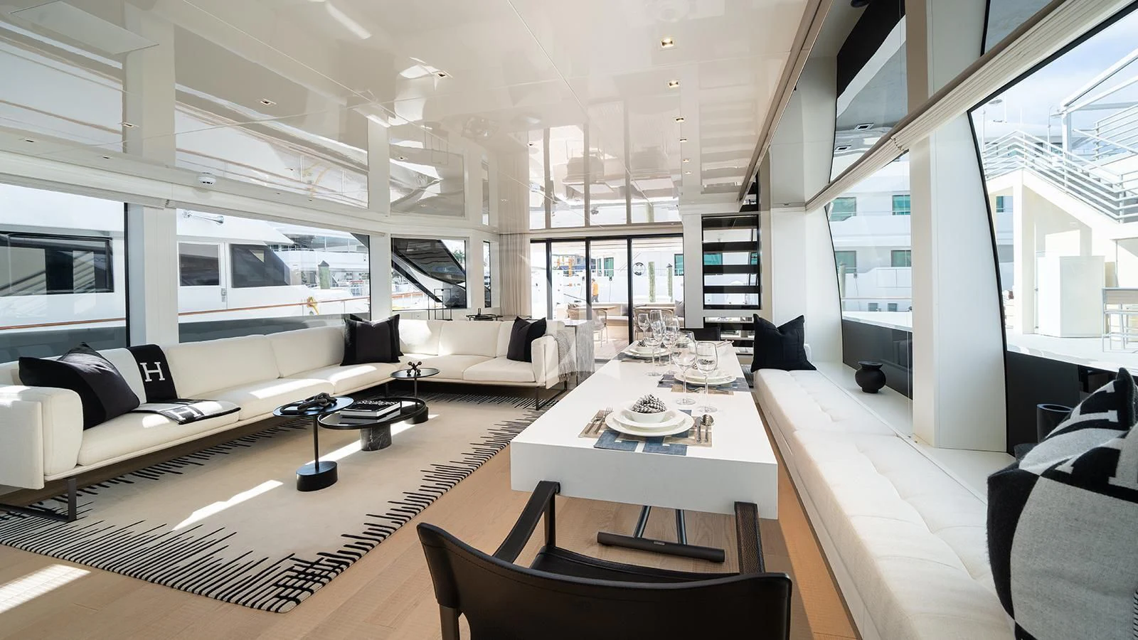 a room with a table chairs and a couch aboard ADIOS Yacht for Charter