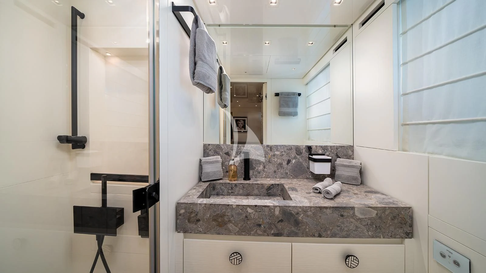 a bathroom with a countertop sink and mirror aboard ADIOS Yacht for Charter