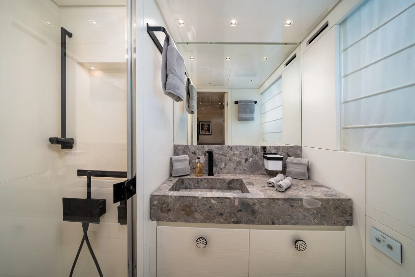 a bathroom with a countertop sink and mirror aboard ADIOS Yacht for Charter