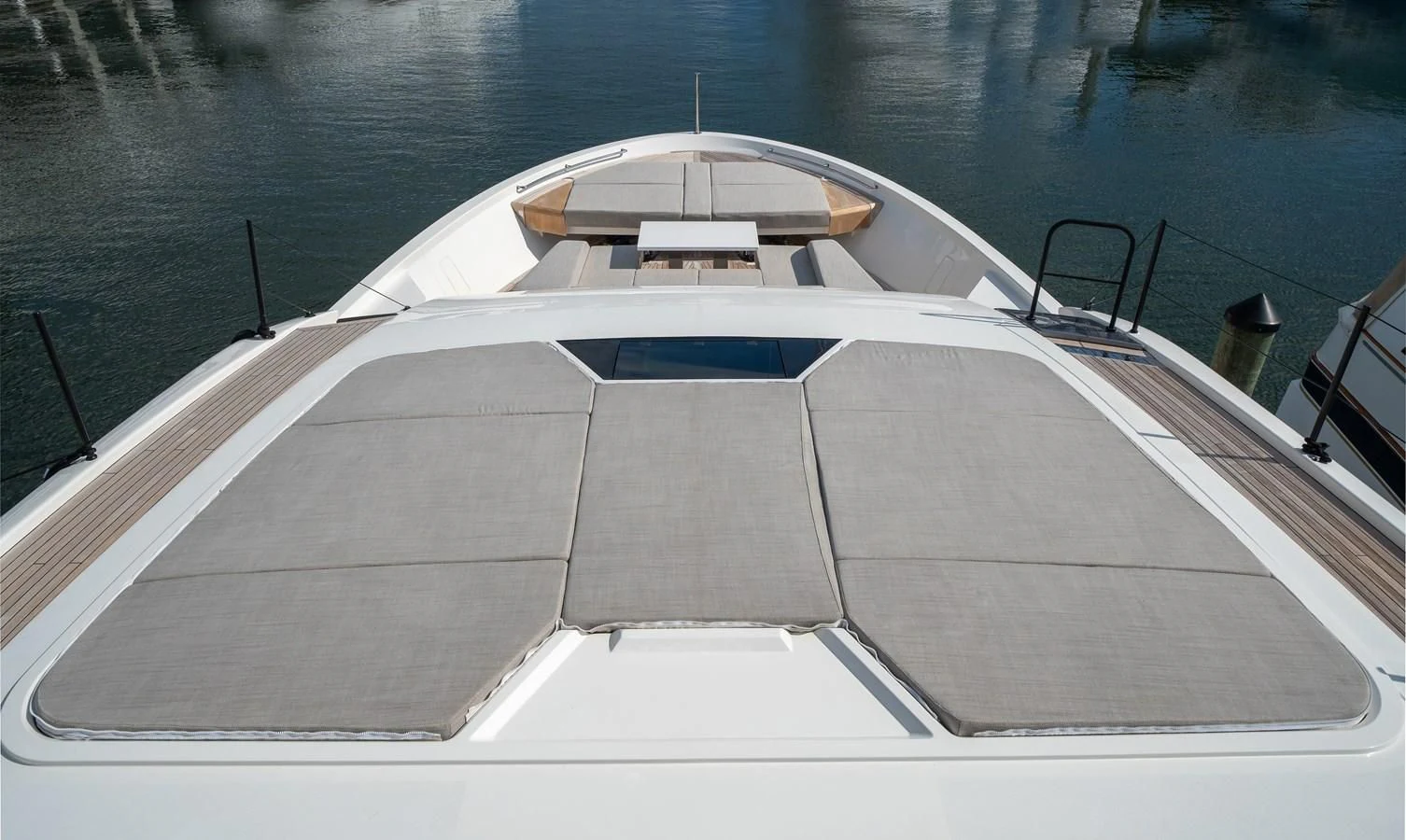 a white boat on a body of water aboard ADIOS Yacht for Charter