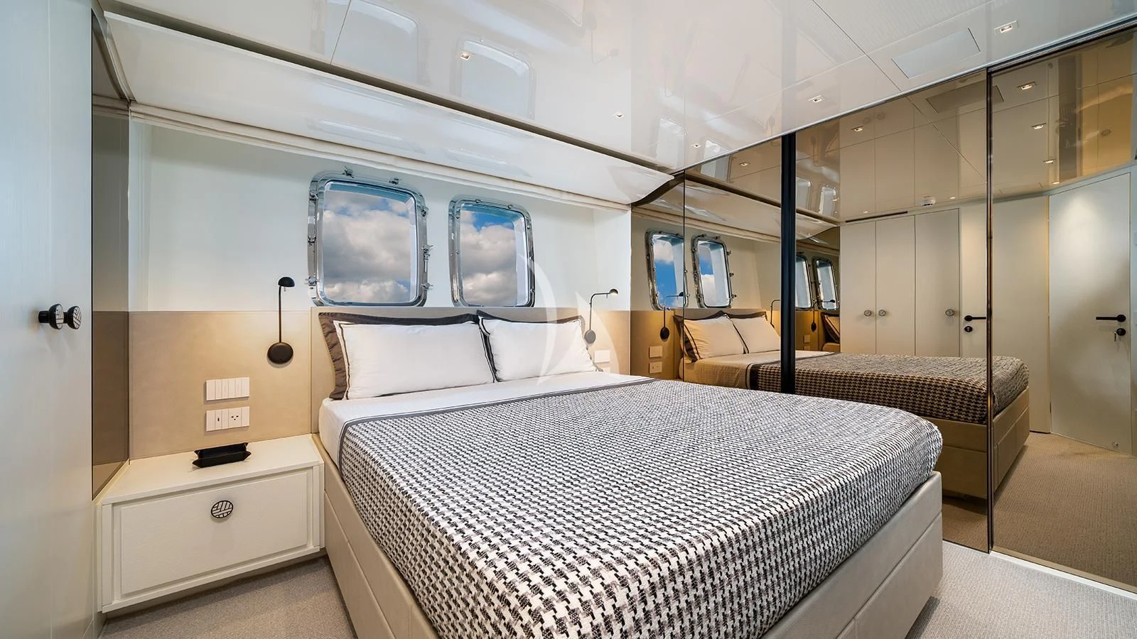 a room with a bed and a window aboard ADIOS Yacht for Charter