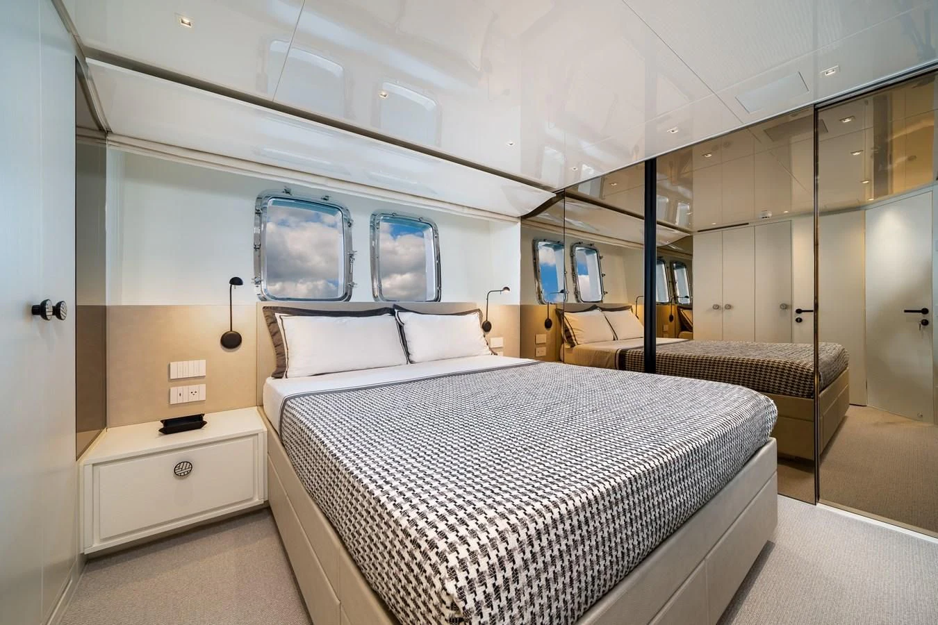 a room with beds and a window aboard ADIOS Yacht for Charter
