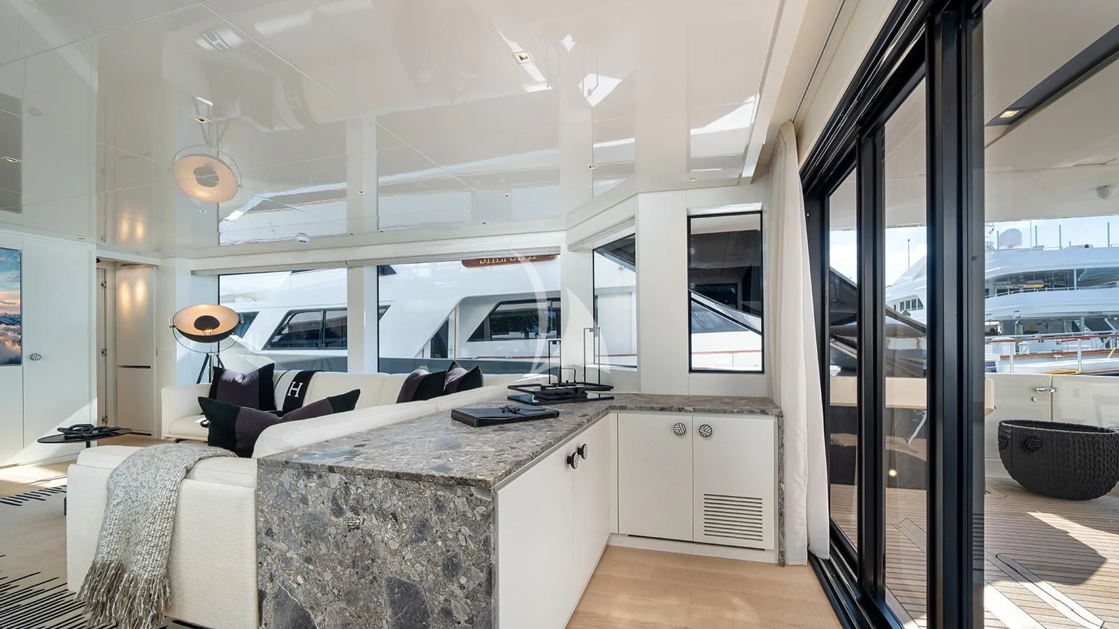 a living room with a large glass door aboard ADIOS Yacht for Charter