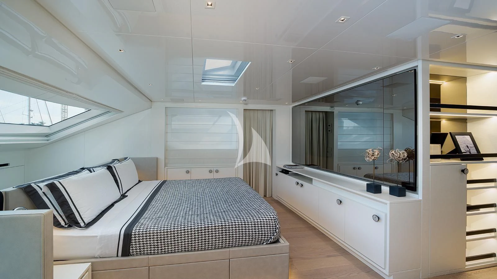 a room with a bed and a desk aboard ADIOS Yacht for Charter