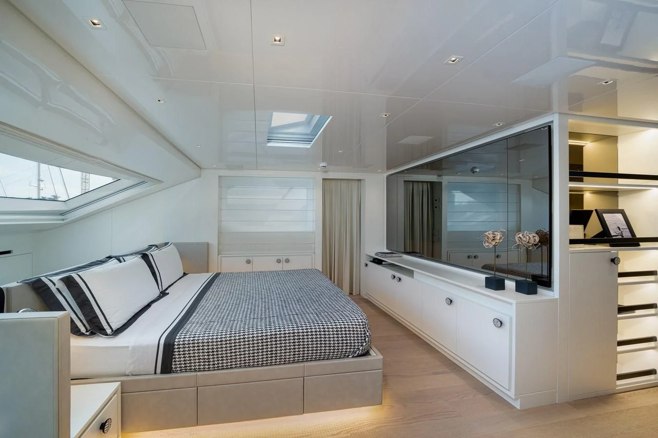 a room with a bed and a desk aboard ADIOS Yacht for Charter