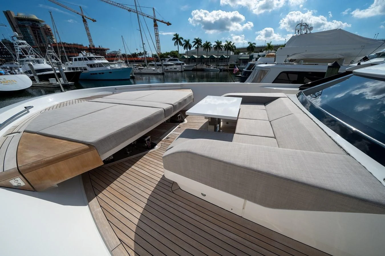 a deck with boats and a large boat in the water aboard ADIOS Yacht for Charter