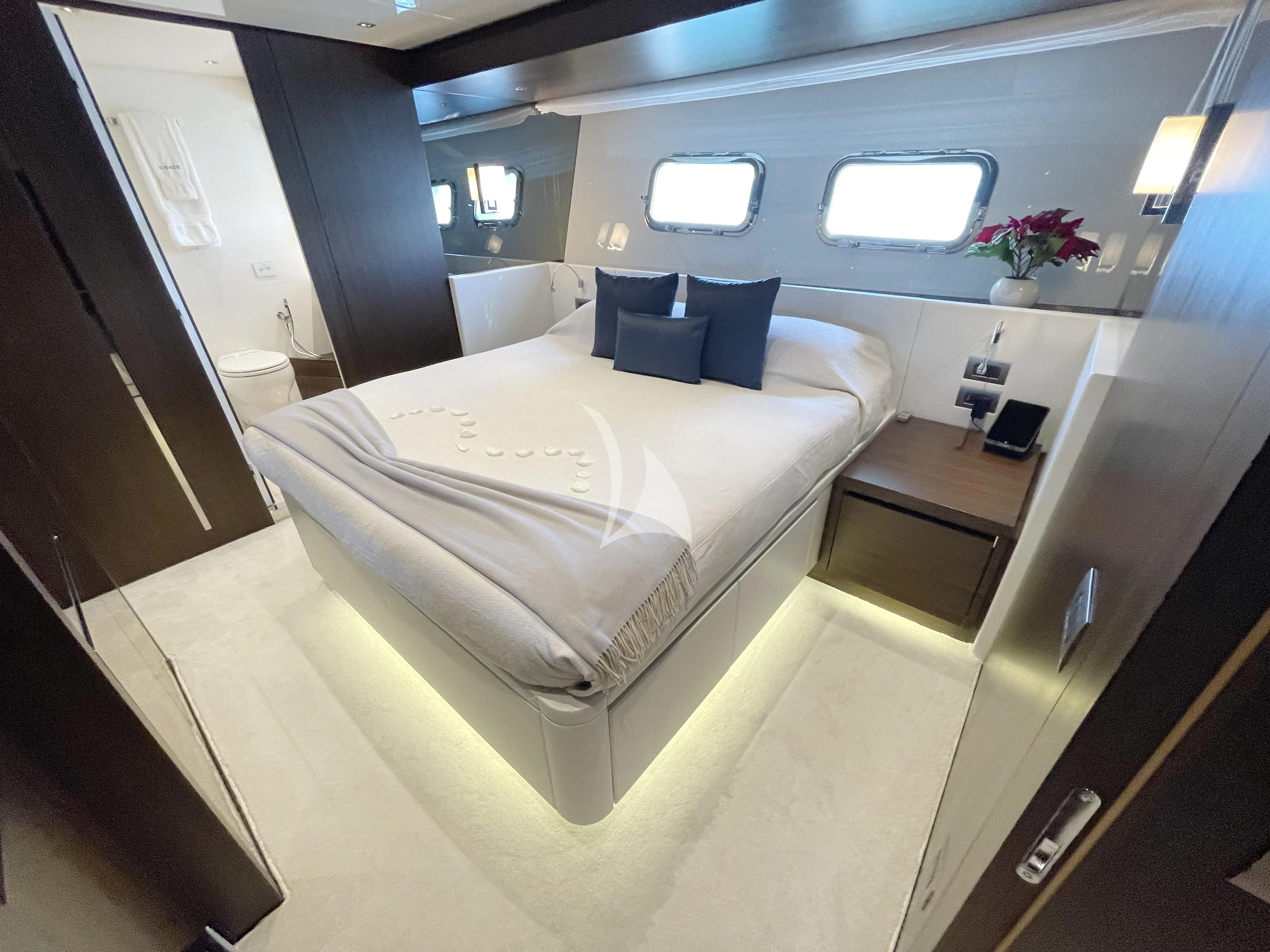 a room with a bed and a mirror aboard C-DAZE Yacht for Sale