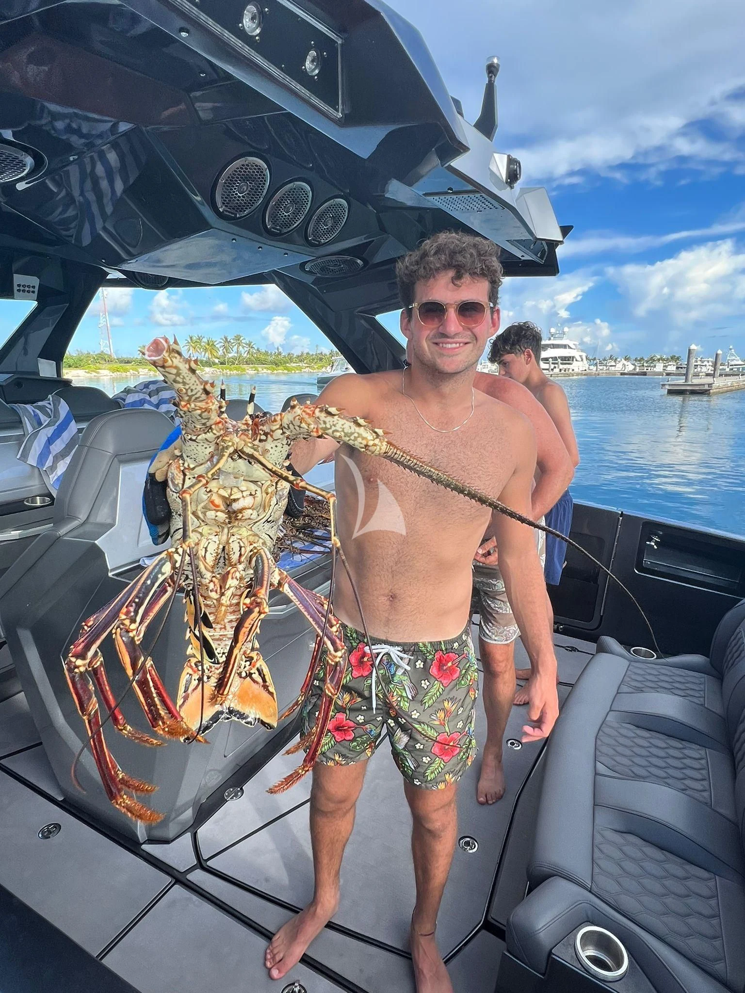 a man standing next to a boat aboard C-DAZE Yacht for Sale