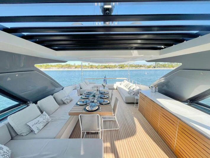 a deck with a view of the ocean and a large cruise ship aboard C-DAZE Yacht for Sale
