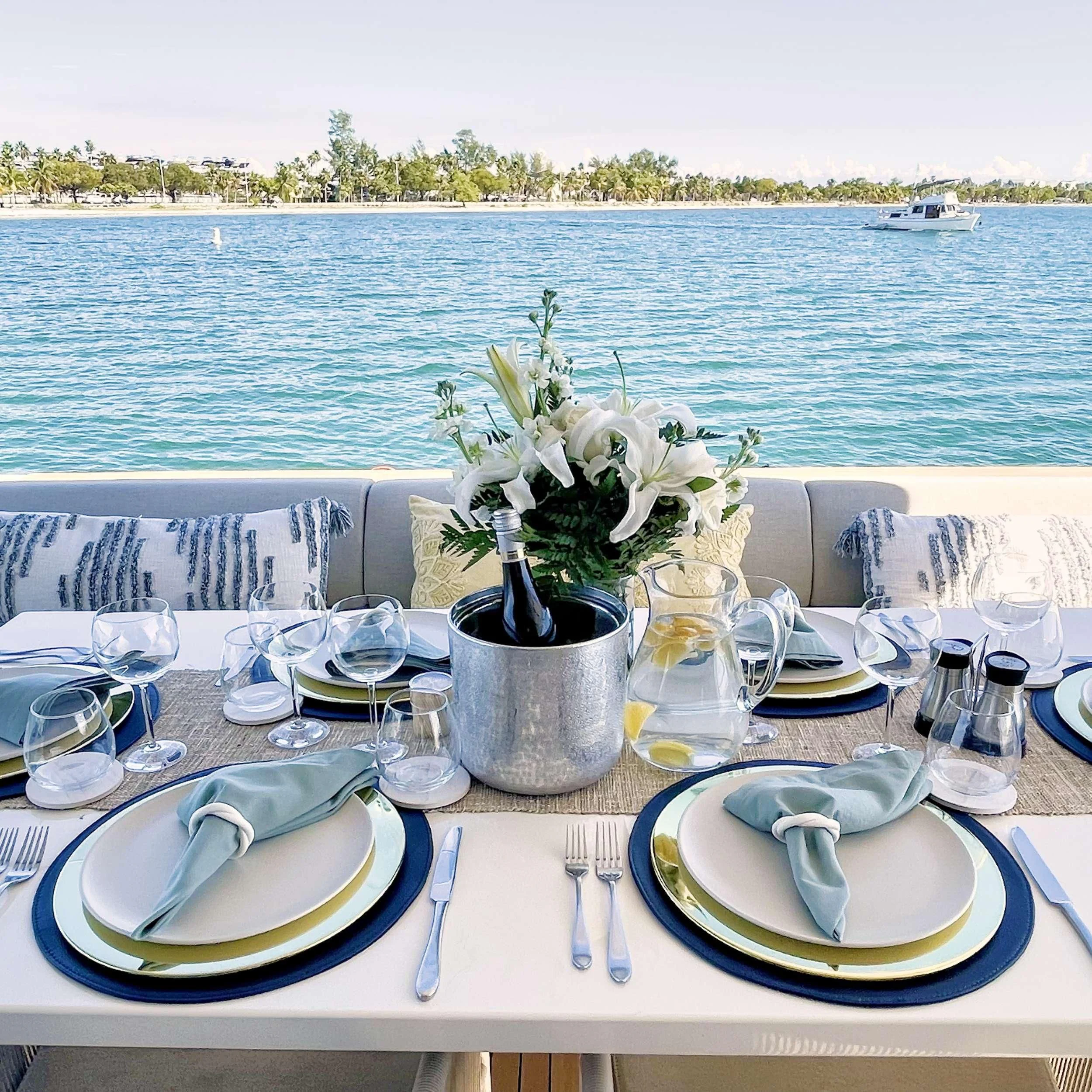 a table with plates and glasses on it aboard C-DAZE Yacht for Sale