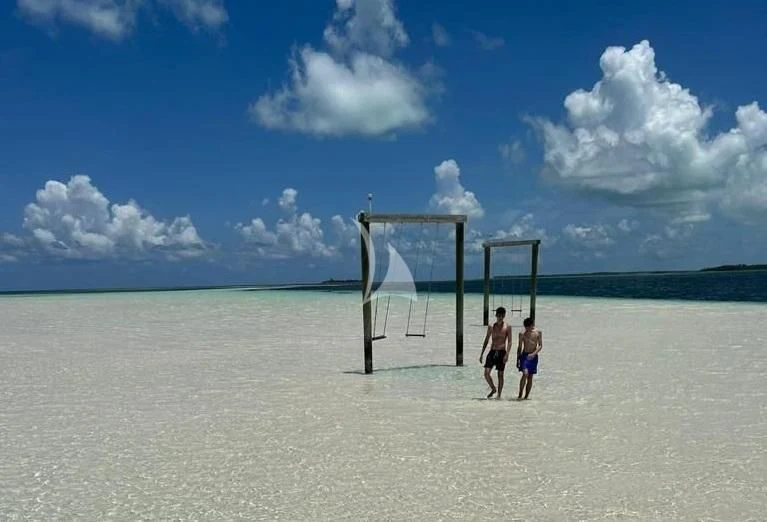 two people standing on a beach aboard C-DAZE Yacht for Sale