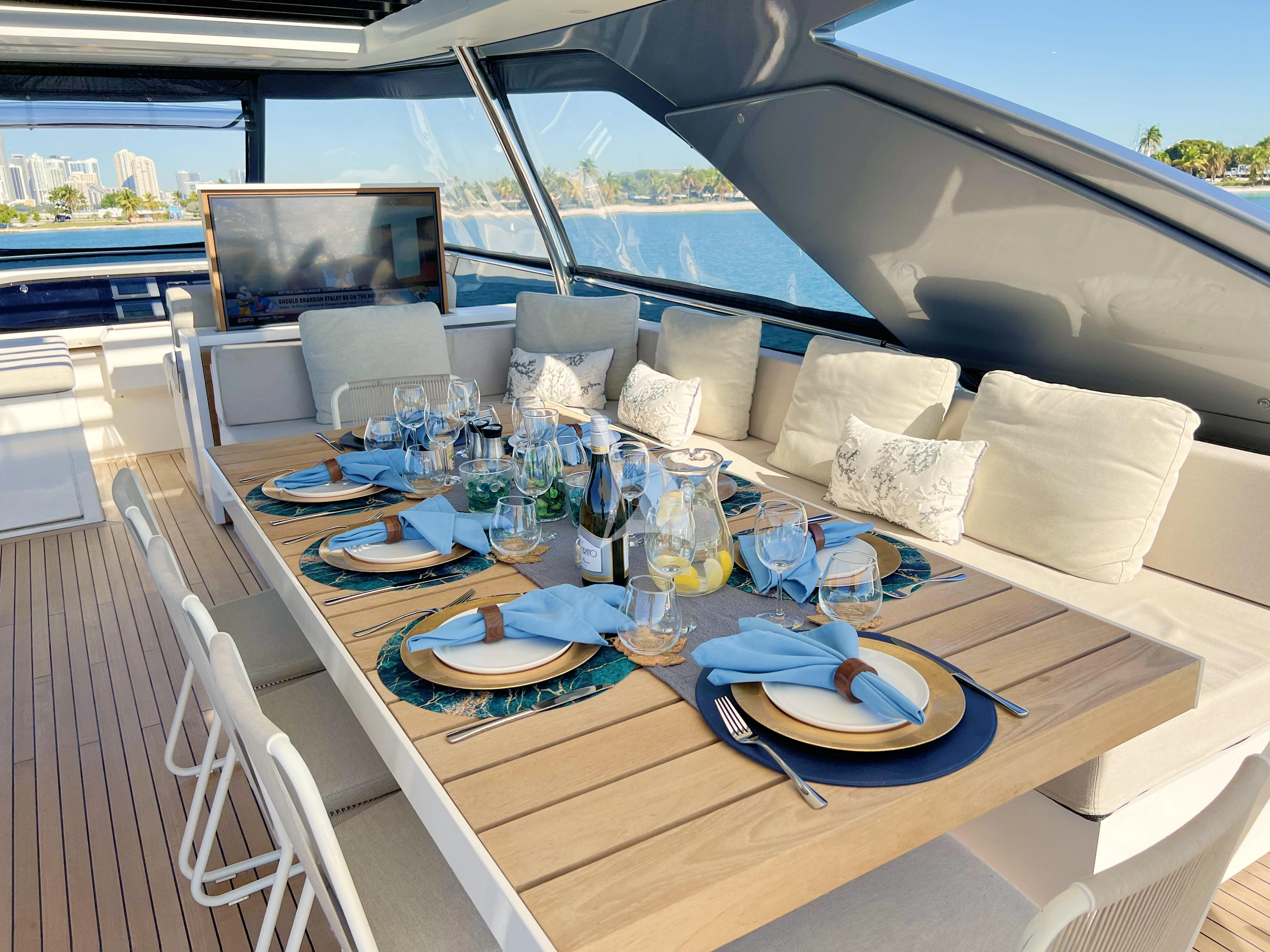 a table with plates and glasses on it aboard C-DAZE Yacht for Sale