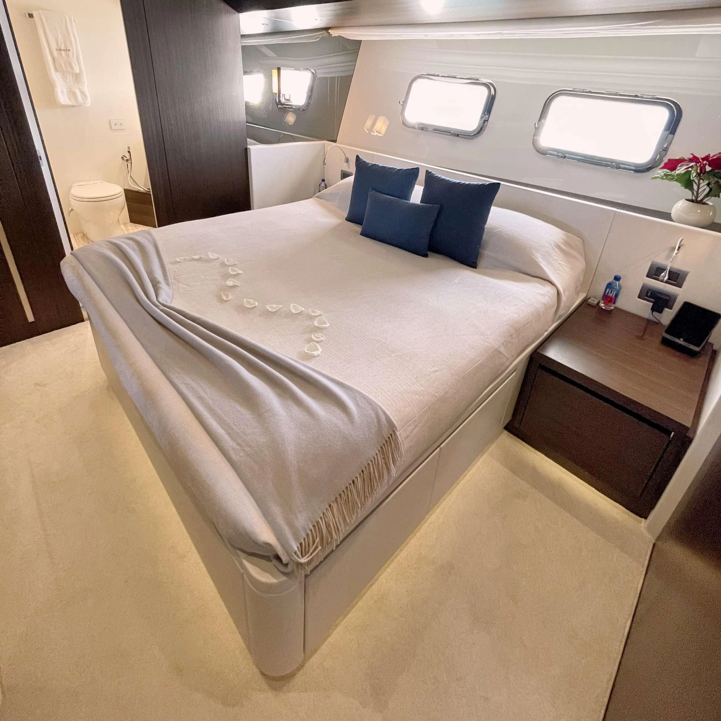 a bed with a white sheet aboard C-DAZE Yacht for Sale