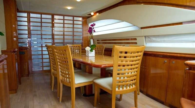 a room with a table and chairs aboard PAMPERO Yacht for Charter