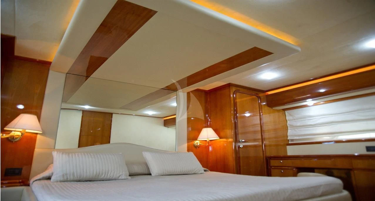 a bed with a white bed spread aboard PAMPERO Yacht for Charter
