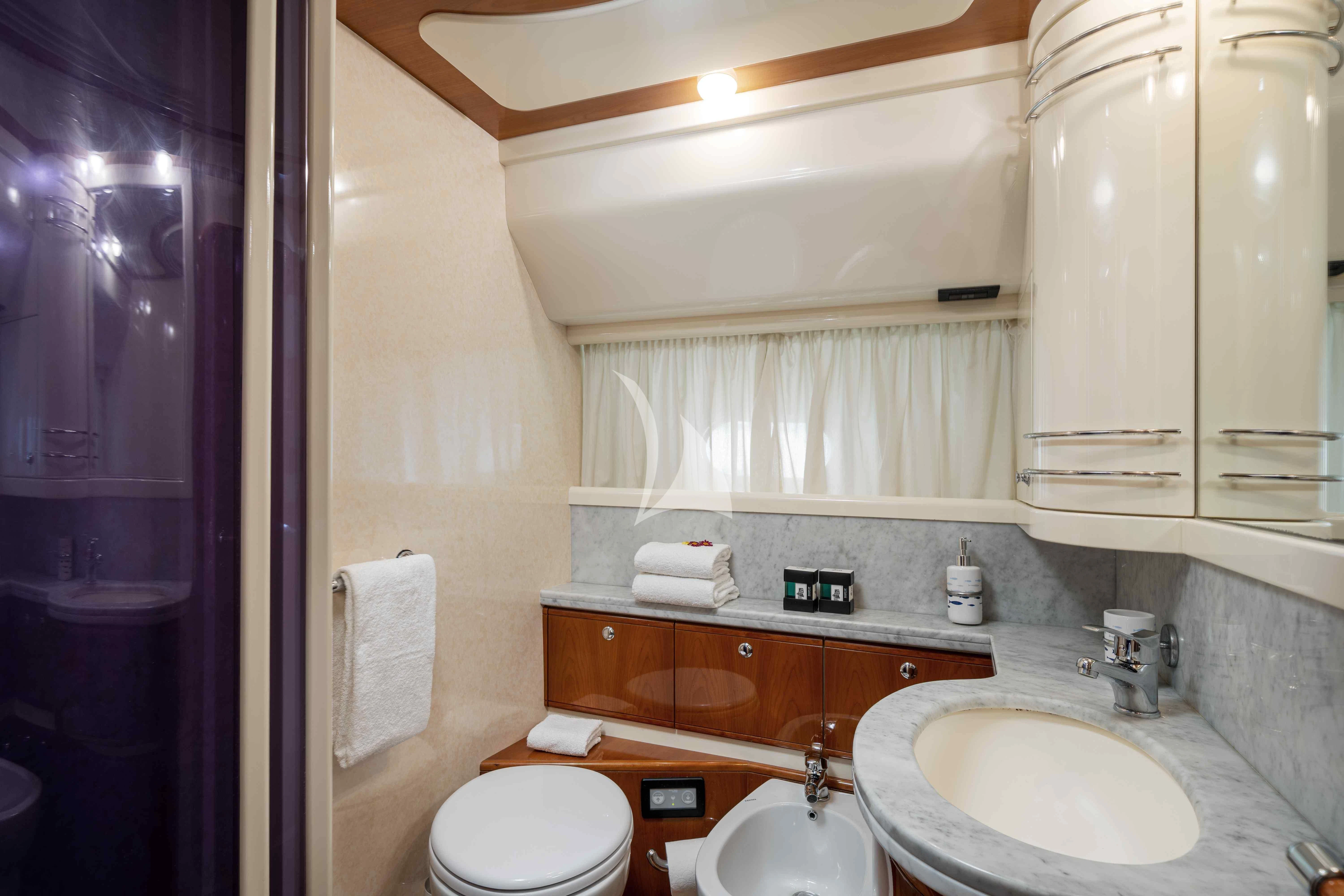 a bathroom with a sink toilet and a mirror aboard PAMPERO Yacht for Charter