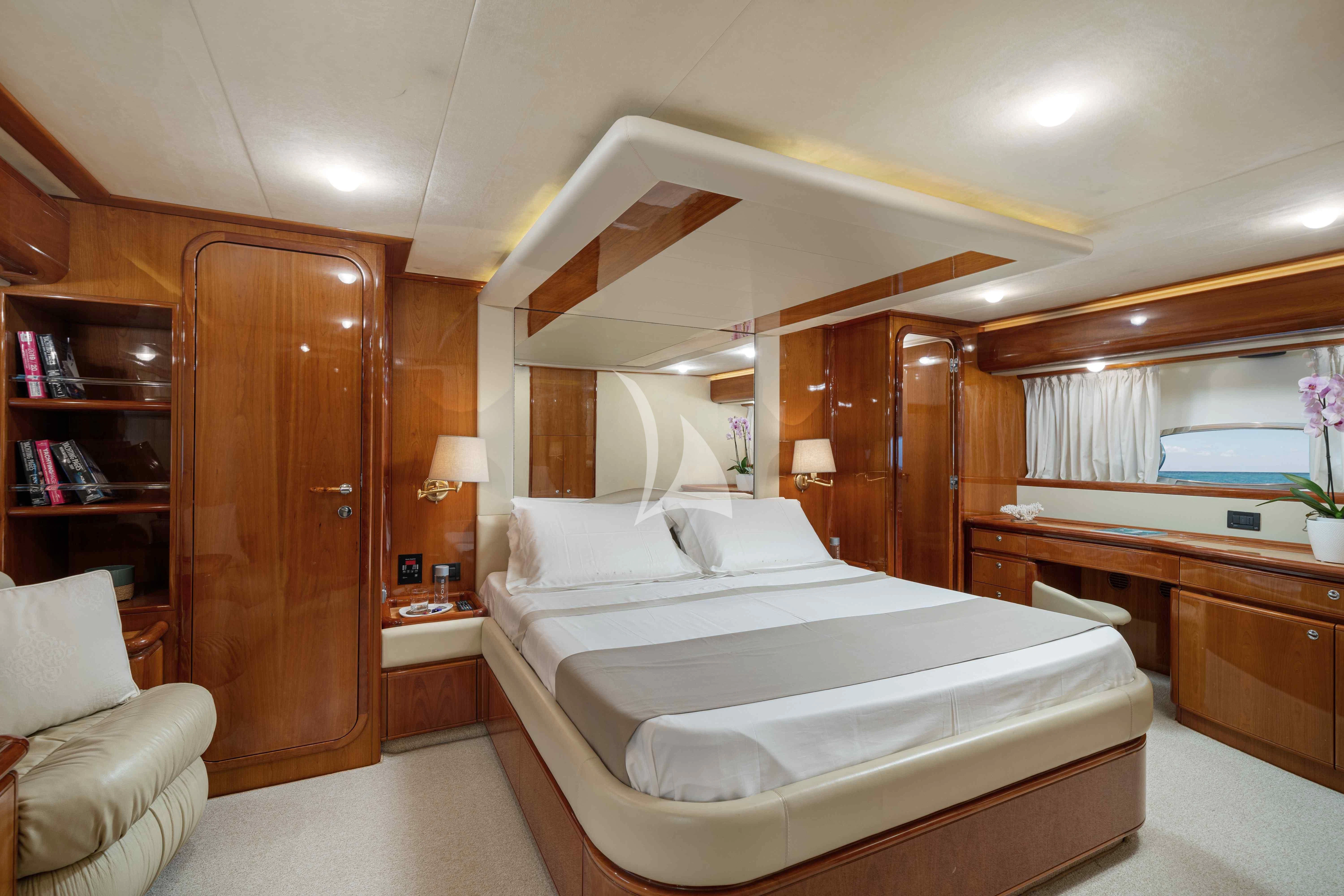 a room with a bed and a mirror aboard PAMPERO Yacht for Charter