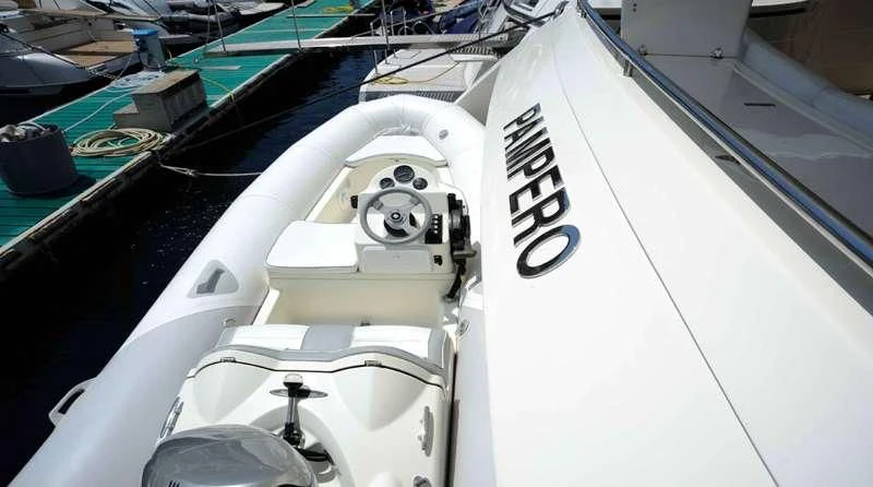 a white boat with a steering wheel aboard PAMPERO Yacht for Charter