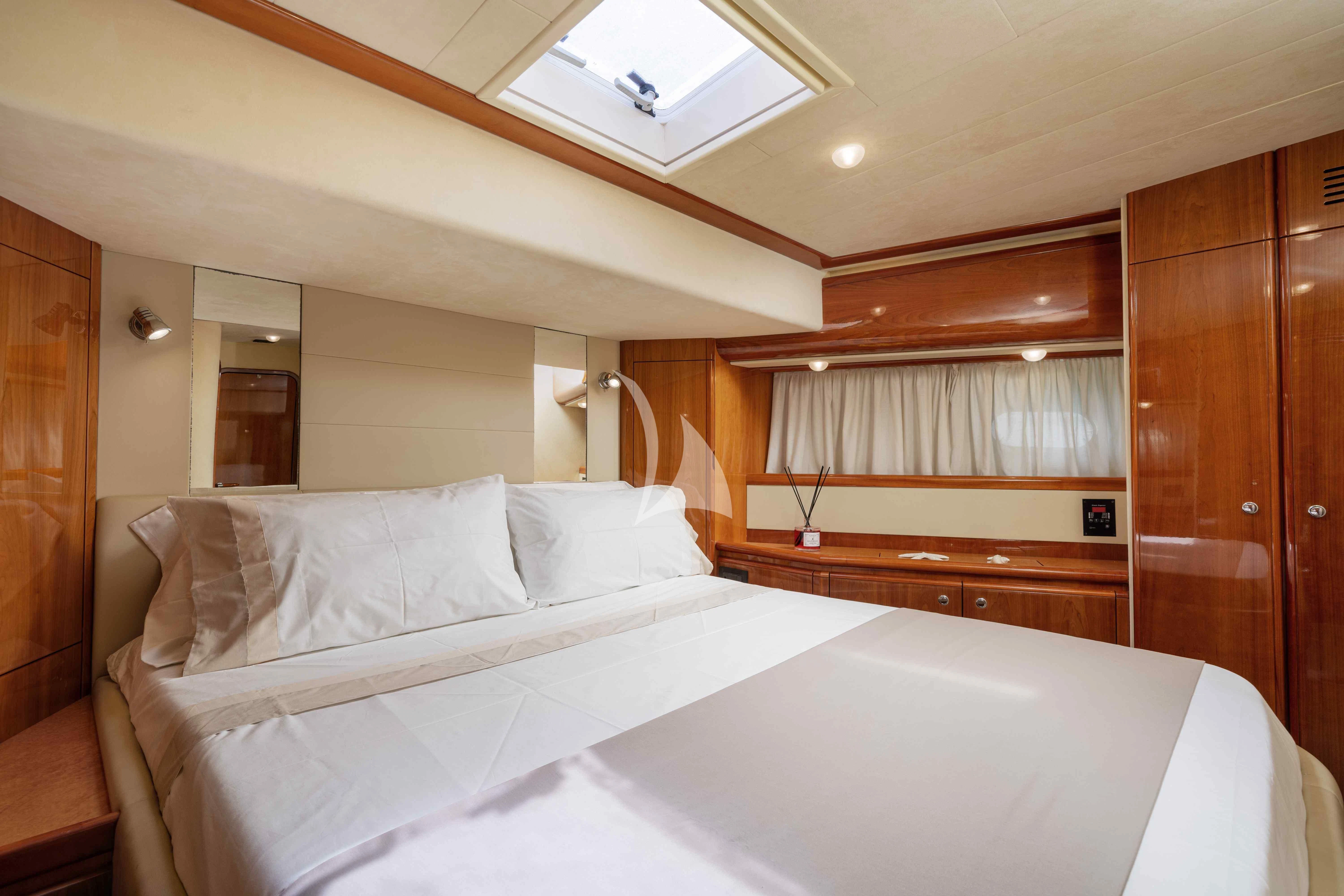 a bed with white sheets aboard PAMPERO Yacht for Charter