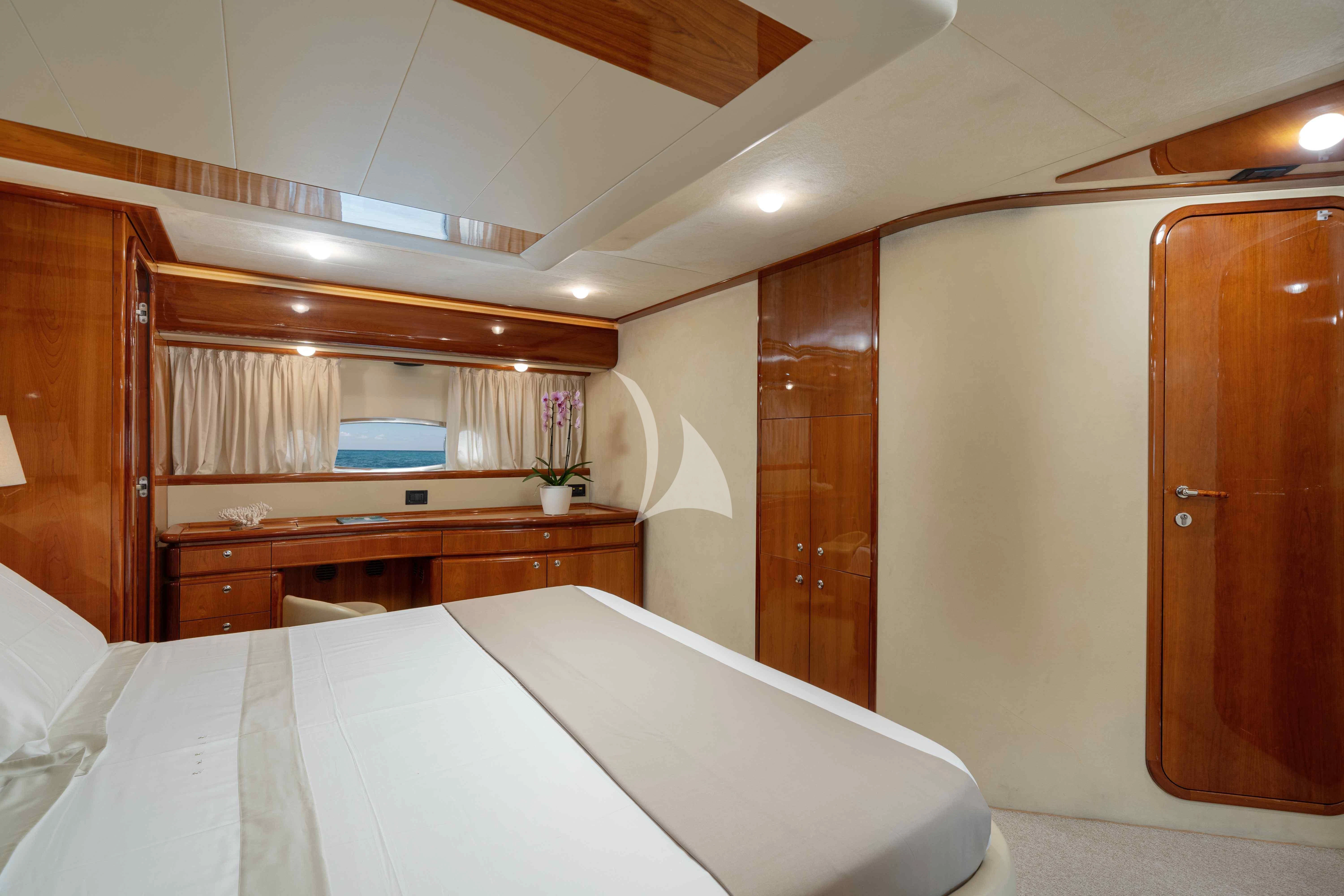 a room with a bed and a closet aboard PAMPERO Yacht for Charter