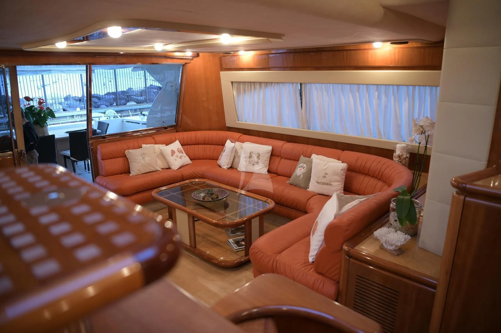 a living room with a large window aboard PAMPERO Yacht for Charter