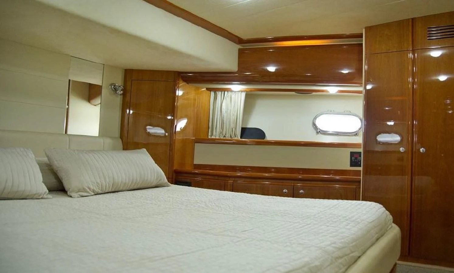 a bed with a white sheet aboard PAMPERO Yacht for Charter