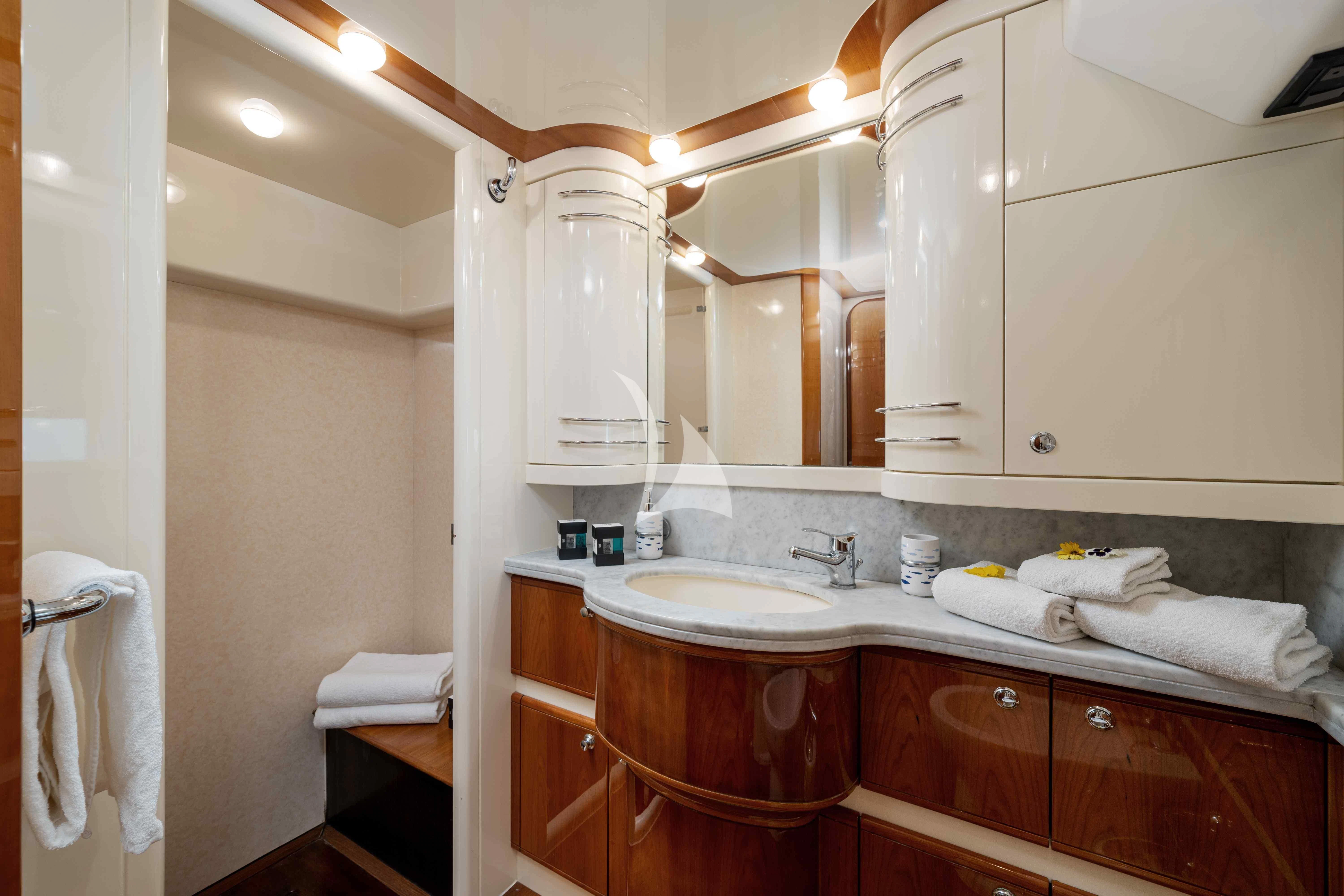 a bathroom with a sink and cabinets aboard PAMPERO Yacht for Charter