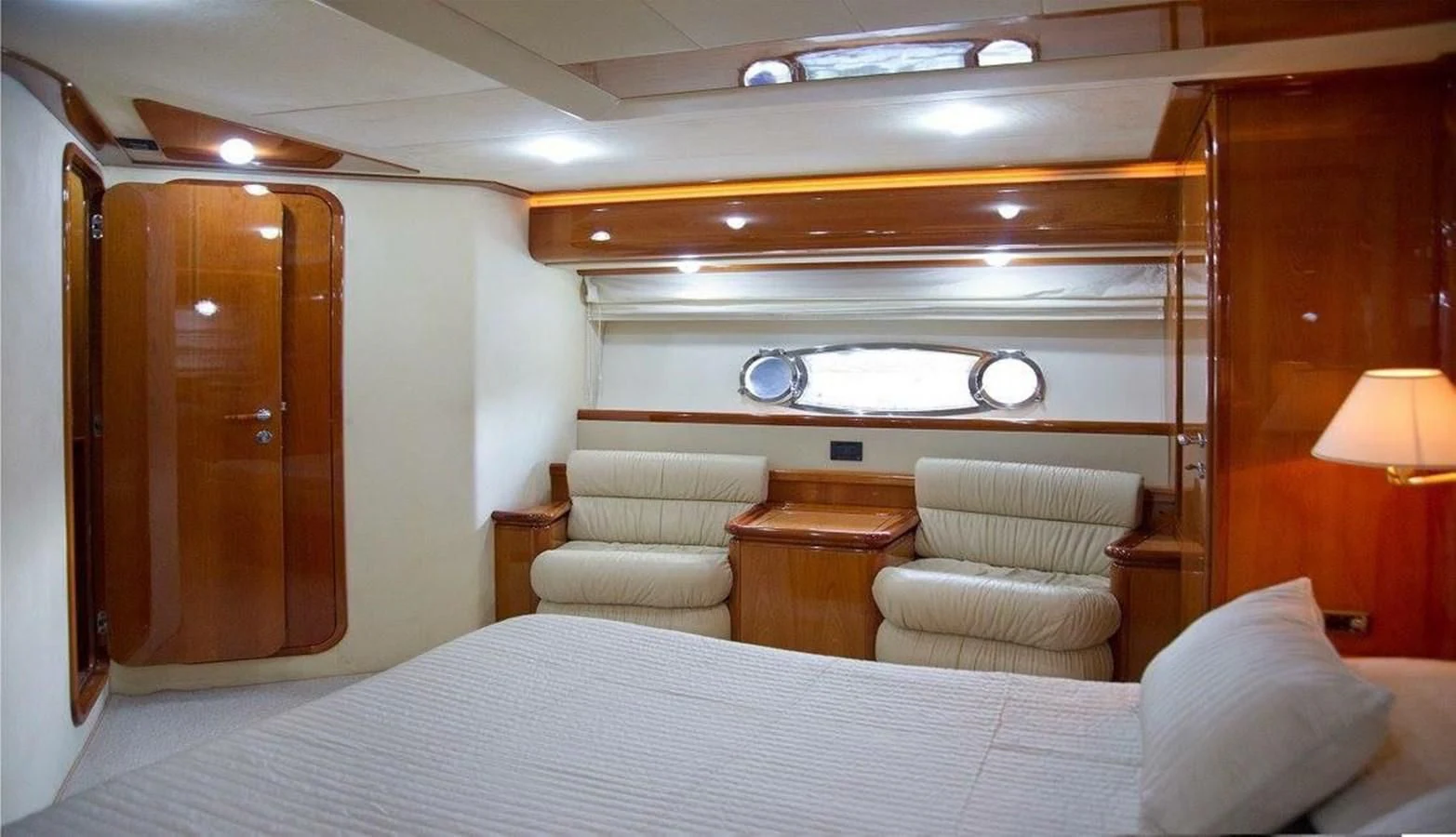 a bed room with a bed and a desk aboard PAMPERO Yacht for Charter