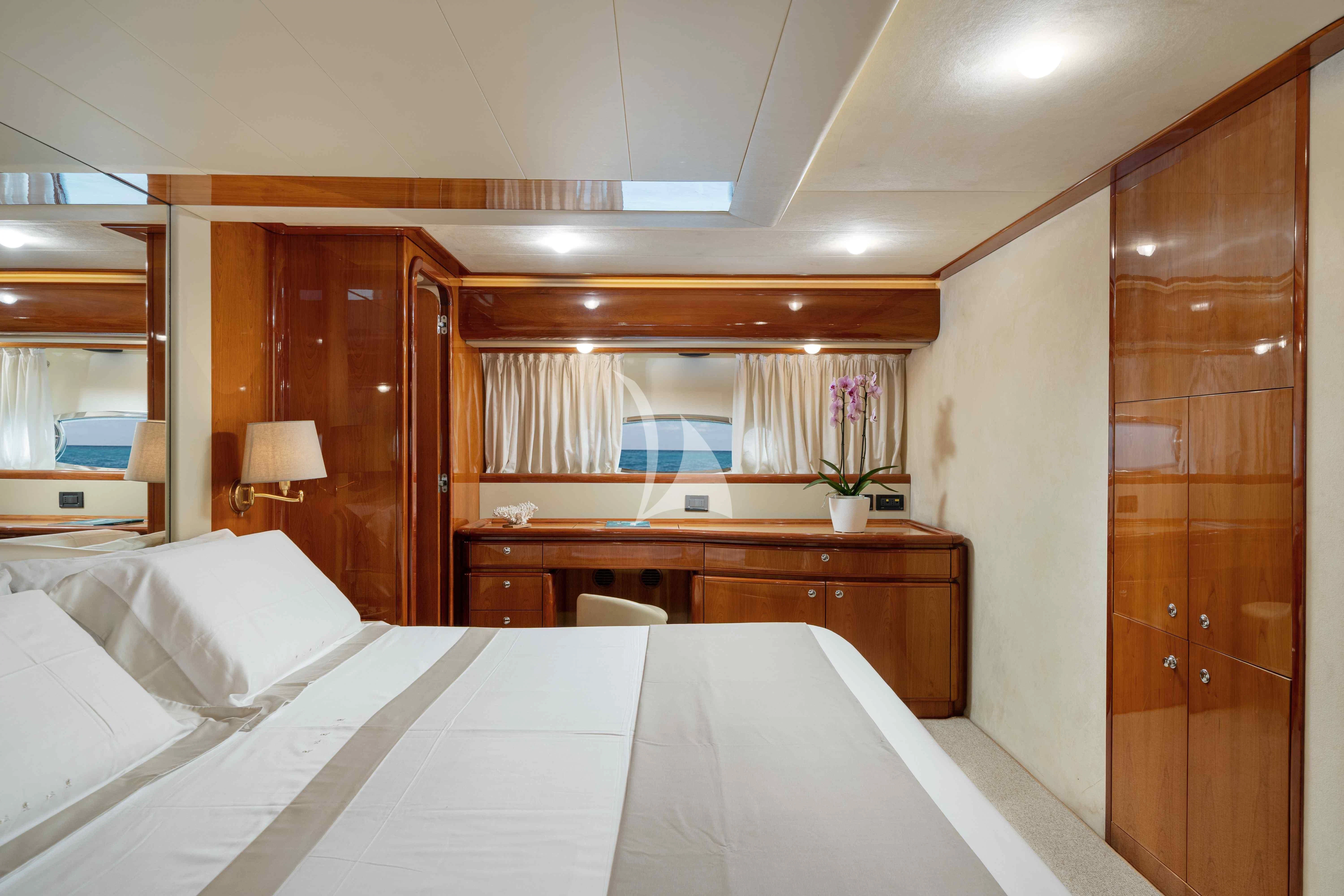 a room with a bed and a desk aboard PAMPERO Yacht for Charter