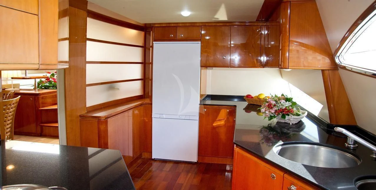 a kitchen with wooden cabinets aboard PAMPERO Yacht for Charter