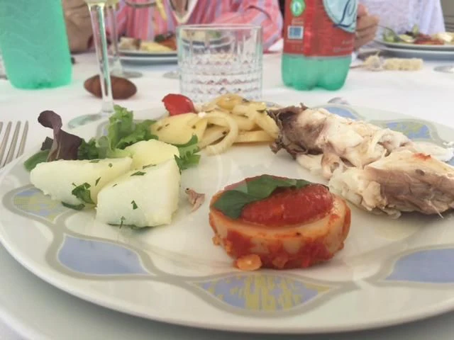 a plate of food aboard PAMPERO Yacht for Charter