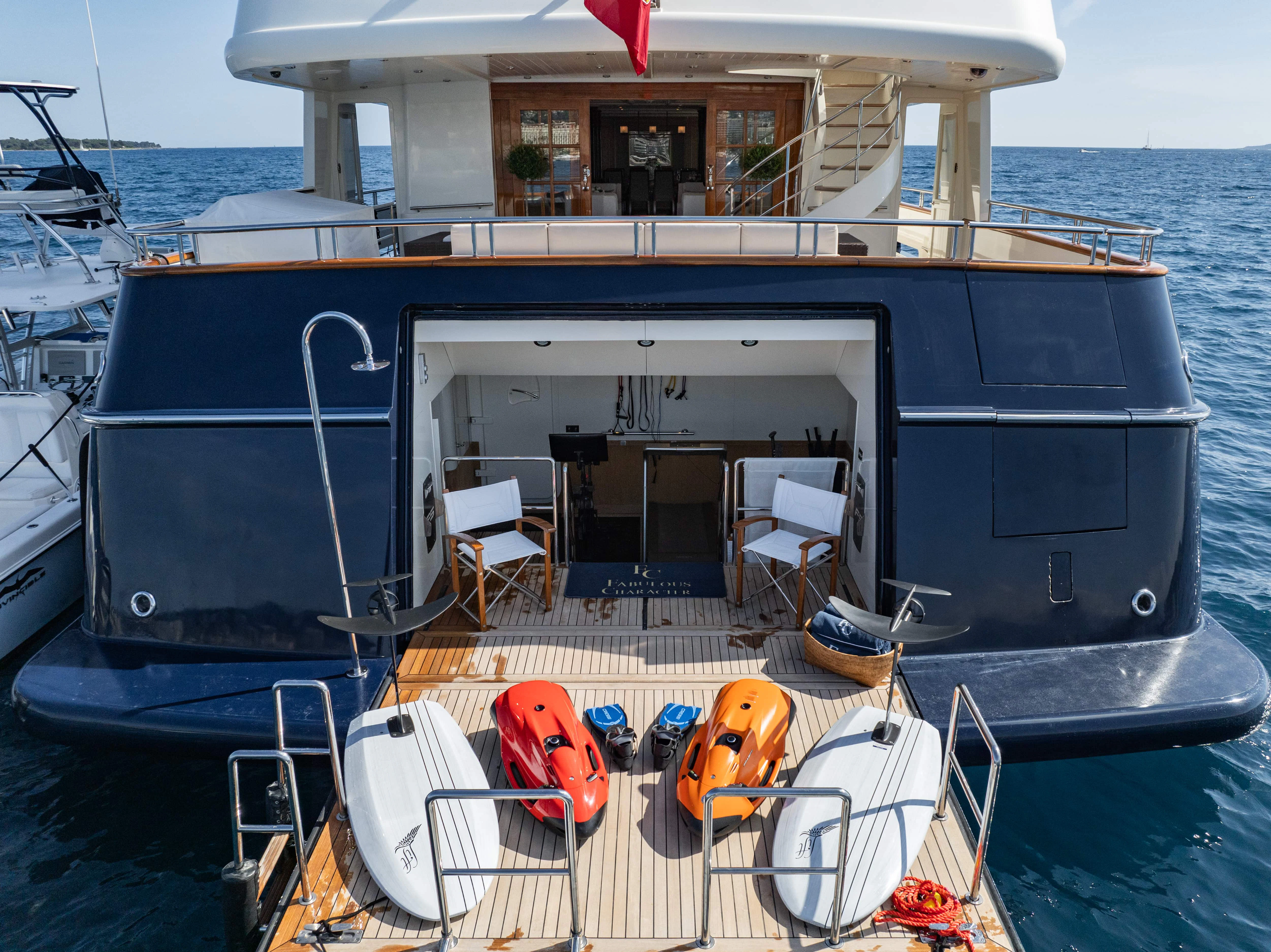 a boat with a deck and chairs on the deck aboard FABULOUS CHARACTER Yacht for Charter