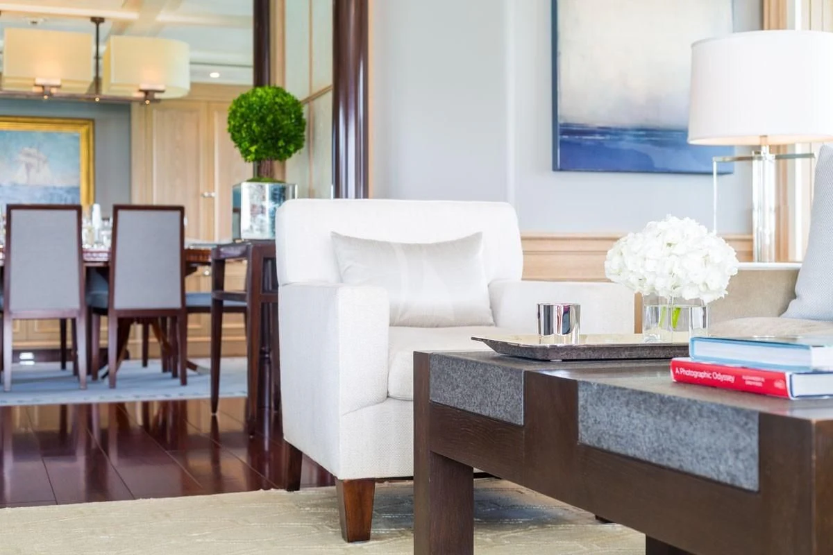 a living room with a white couch and a coffee table aboard FABULOUS CHARACTER Yacht for Charter