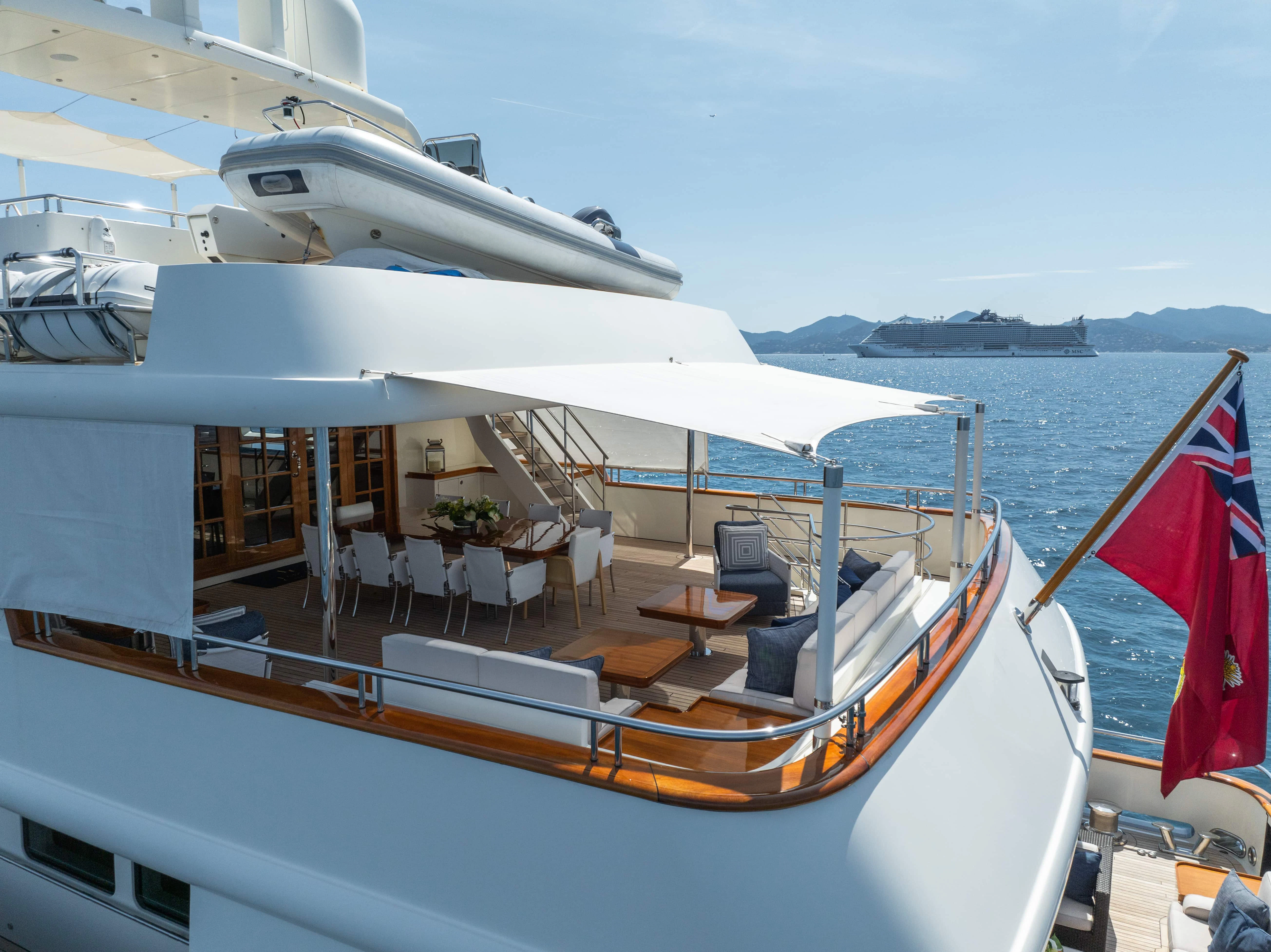 a boat with a table and chairs on the deck aboard FABULOUS CHARACTER Yacht for Charter