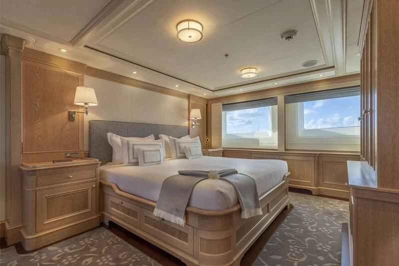 a bedroom with a bed and a window aboard FABULOUS CHARACTER Yacht for Charter