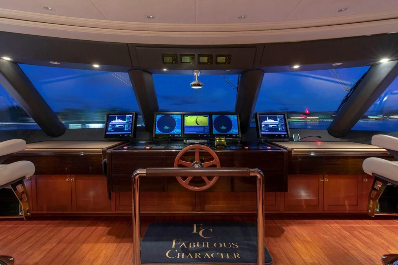 a large room with a bench and a large screen aboard FABULOUS CHARACTER Yacht for Charter