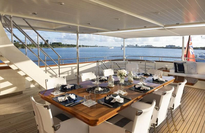 a room with a table and chairs on it aboard FABULOUS CHARACTER Yacht for Charter