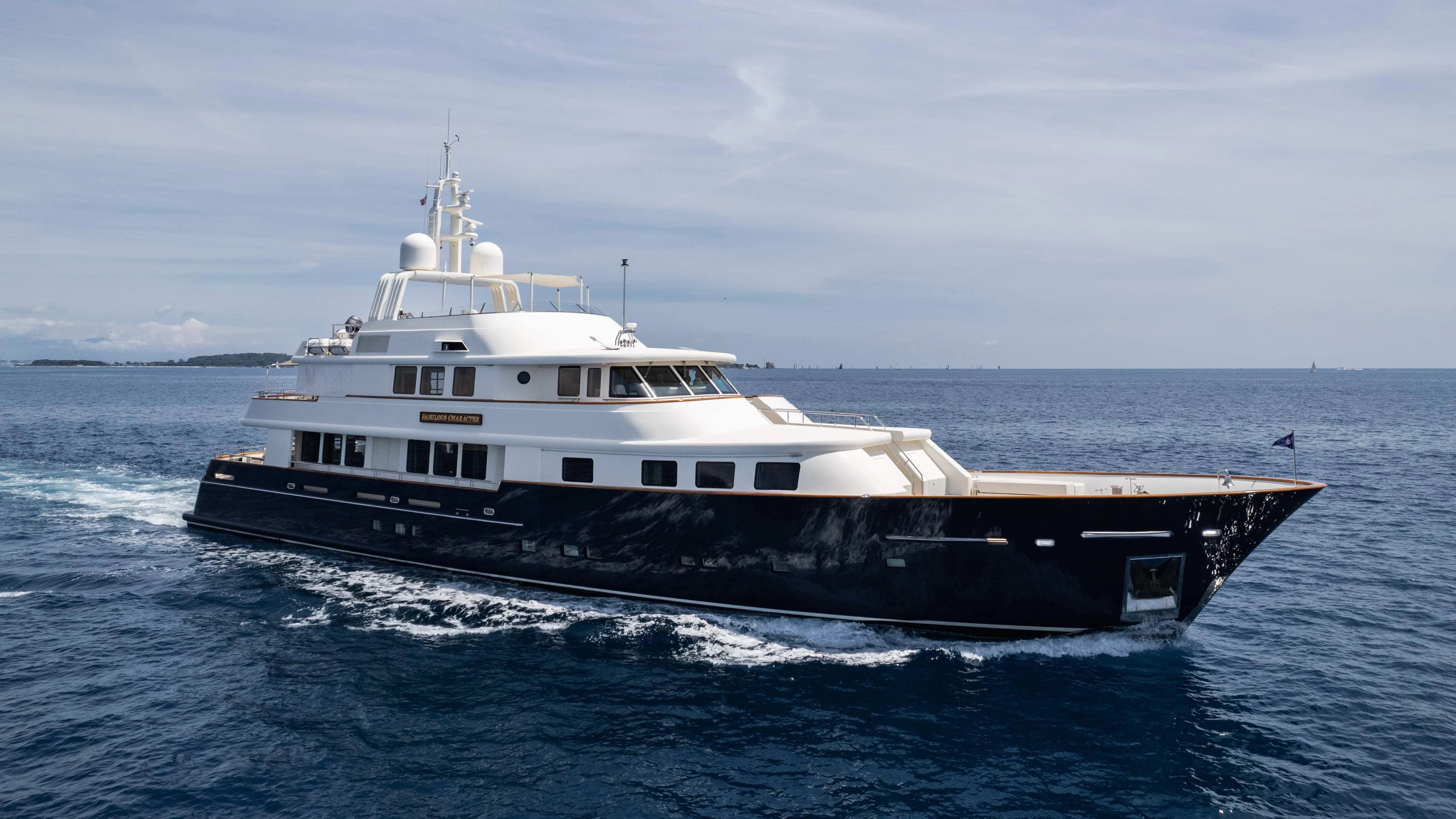 a large white boat in the water aboard FABULOUS CHARACTER Yacht for Charter