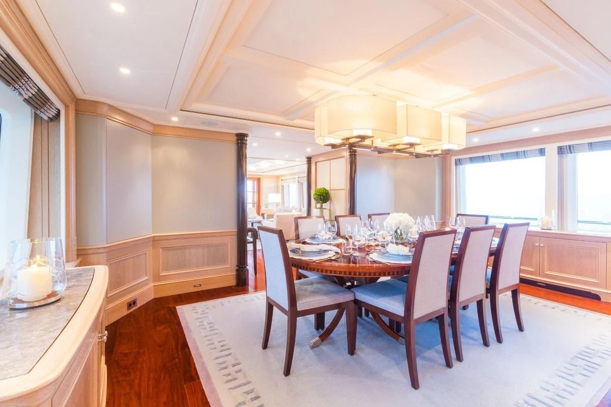 a dining room with a table and chairs aboard FABULOUS CHARACTER Yacht for Charter