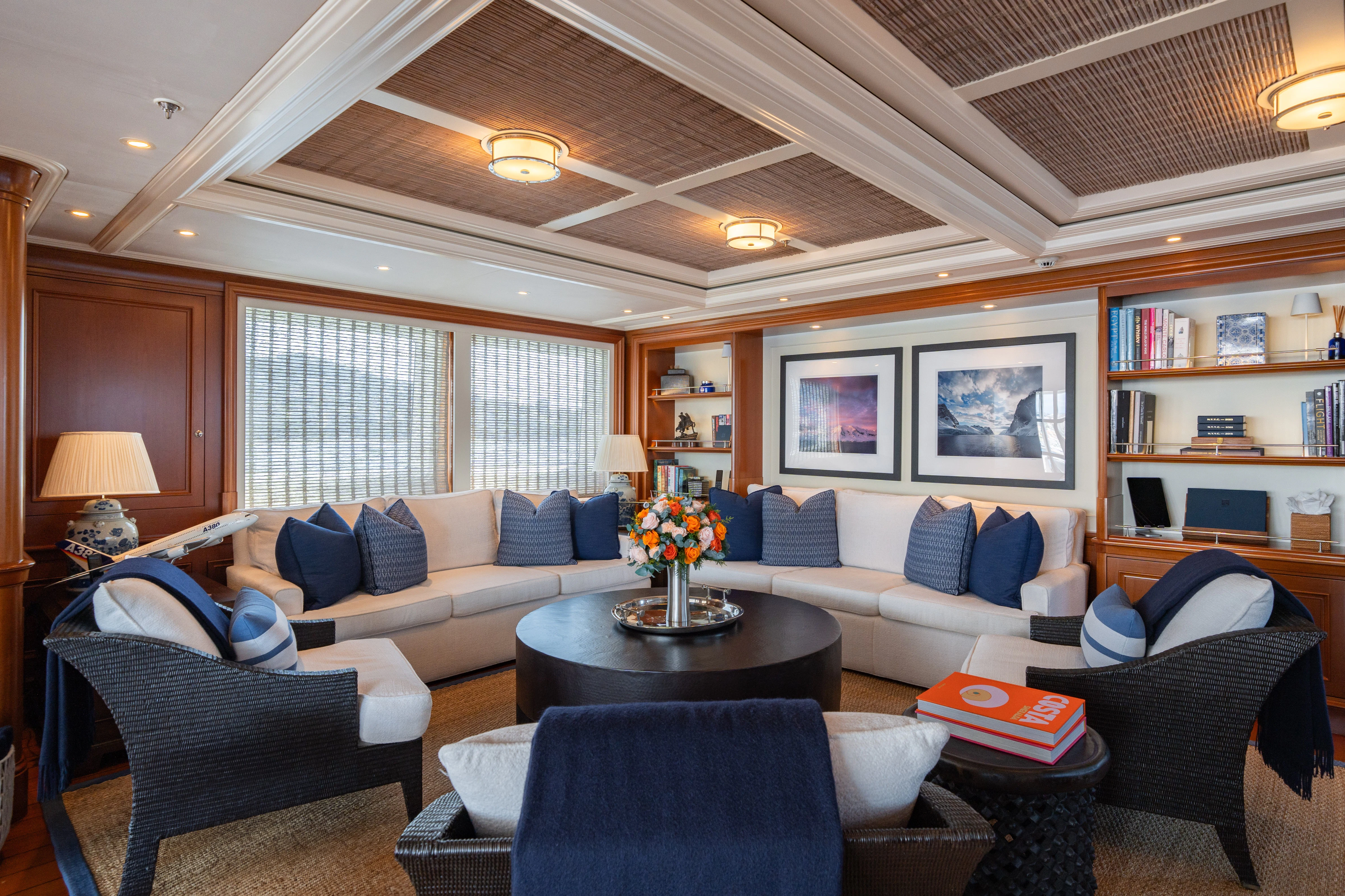 a living room with a large window aboard FABULOUS CHARACTER Yacht for Charter