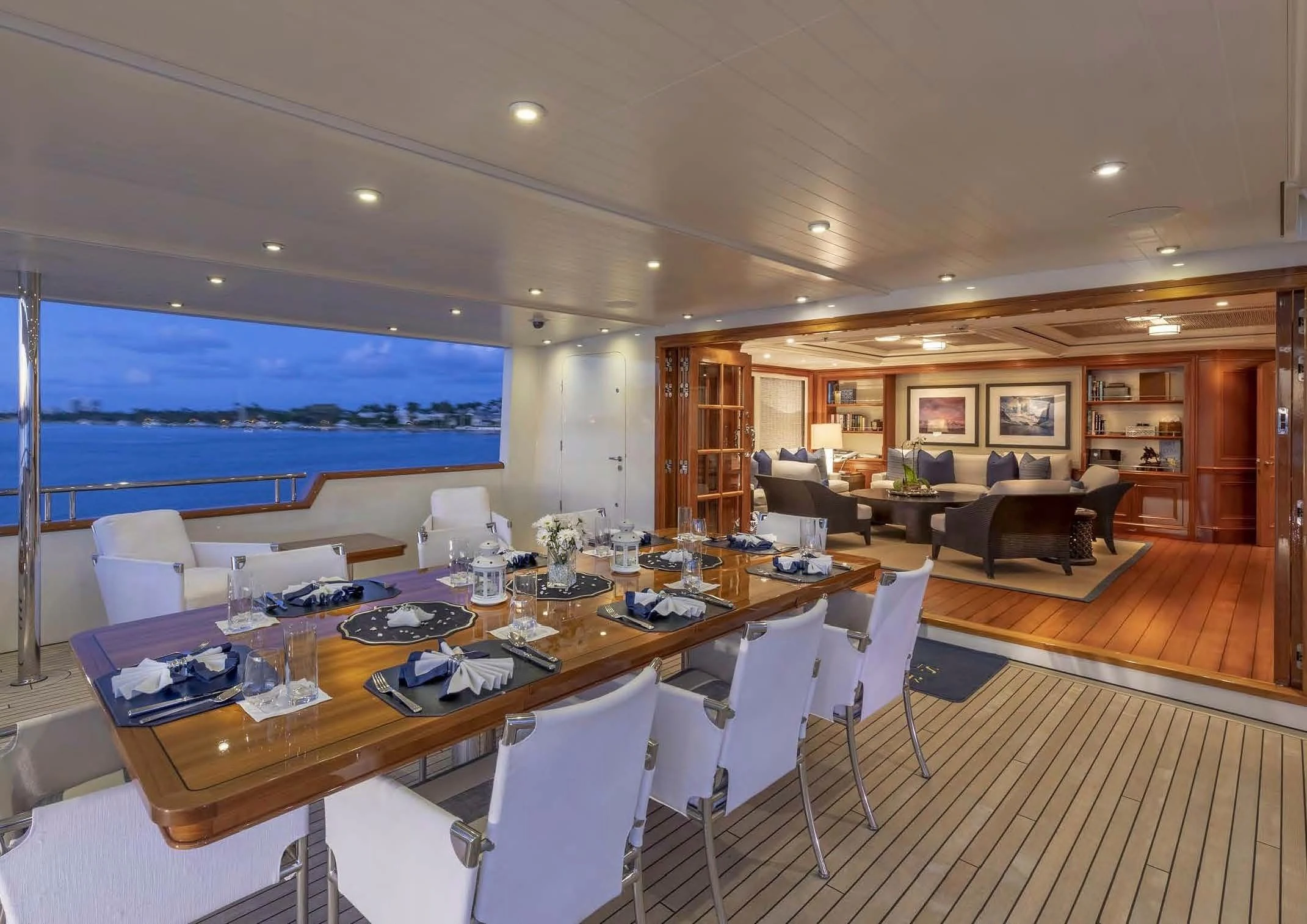 a large room with a table and chairs aboard FABULOUS CHARACTER Yacht for Charter