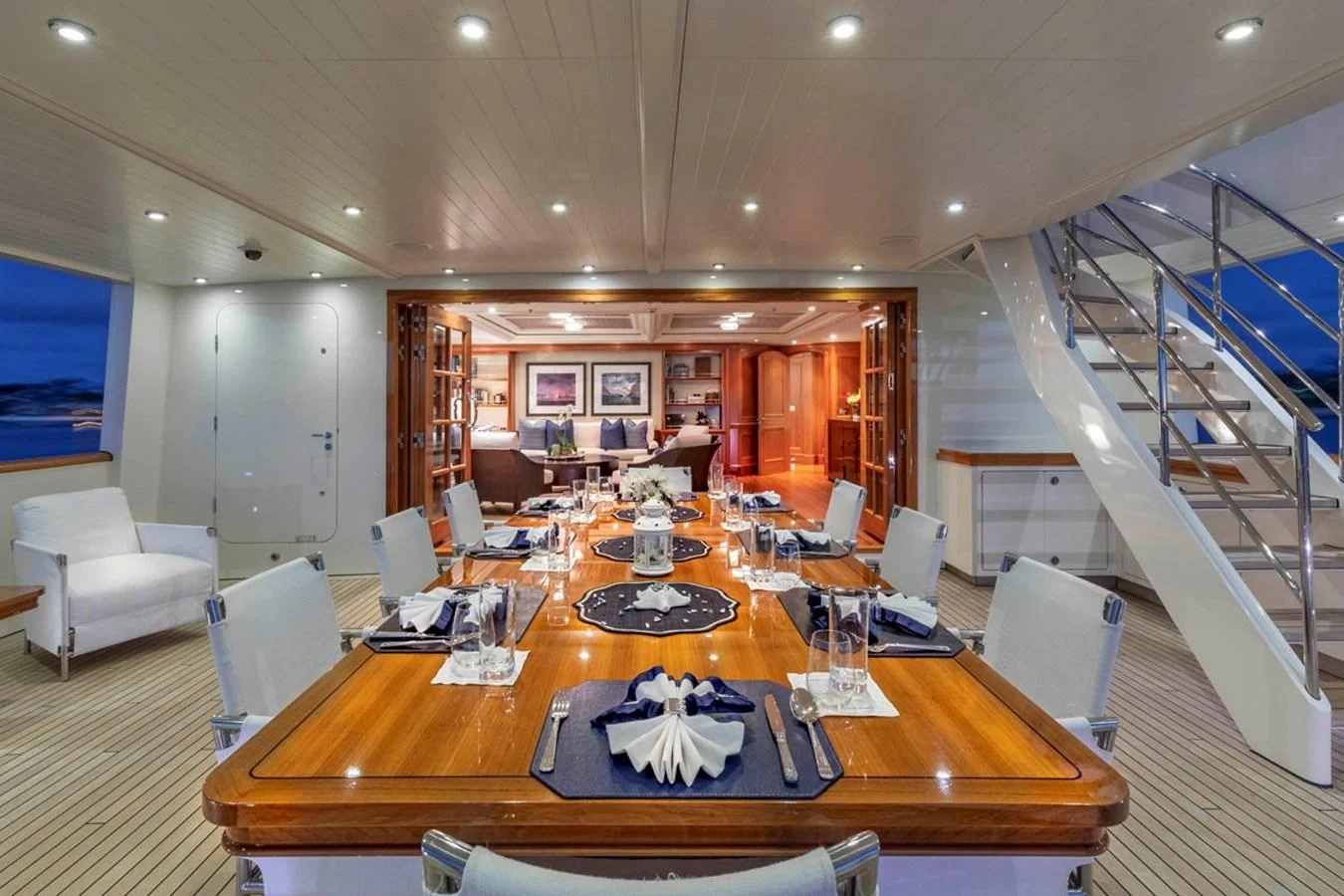 a large dining room with a staircase aboard FABULOUS CHARACTER Yacht for Charter